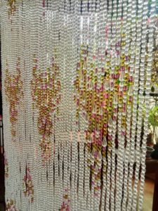 Bead Curtain Shimmering In Sunlight In Balcony Doorway